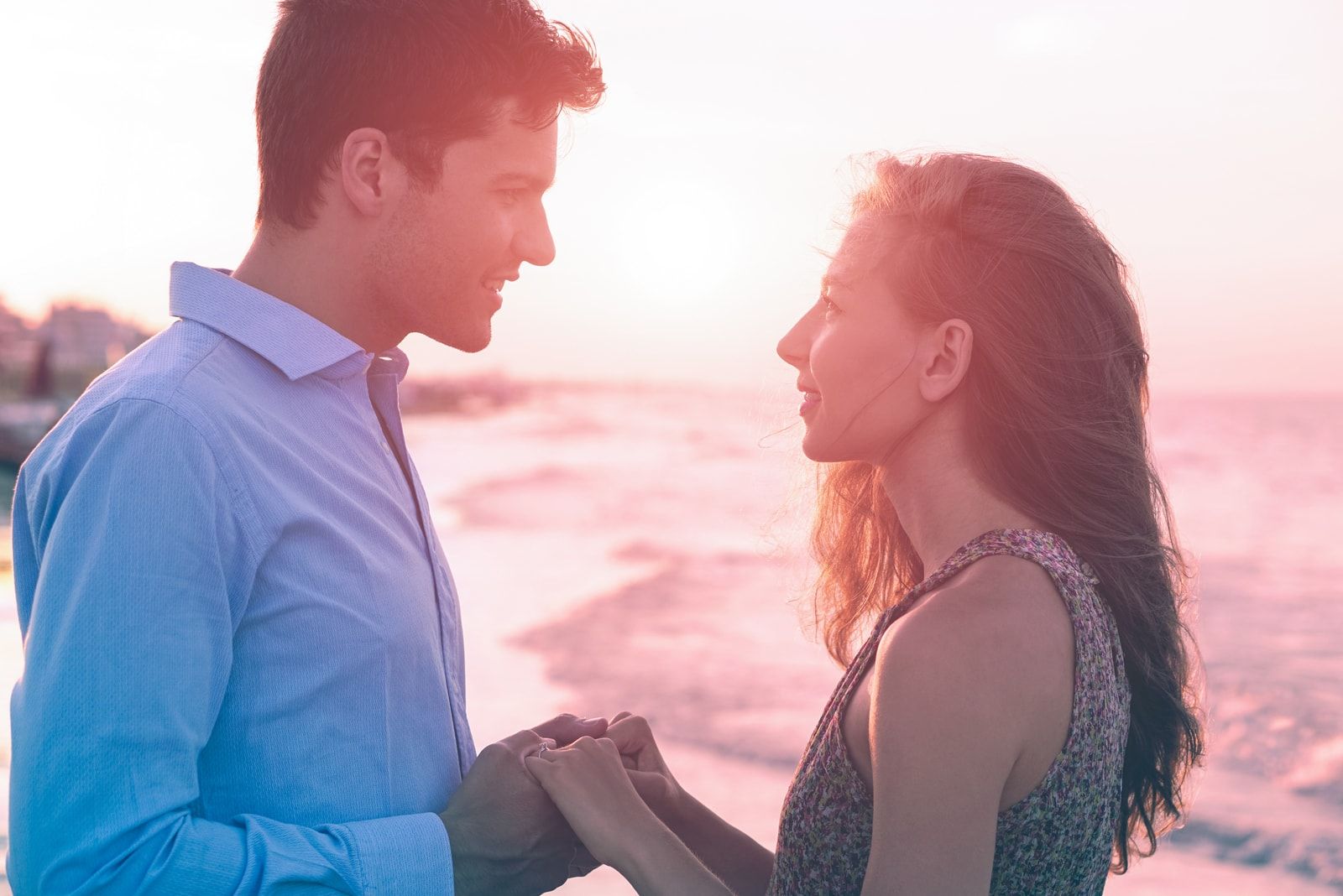 couple holding hands and looking each other in the eyes