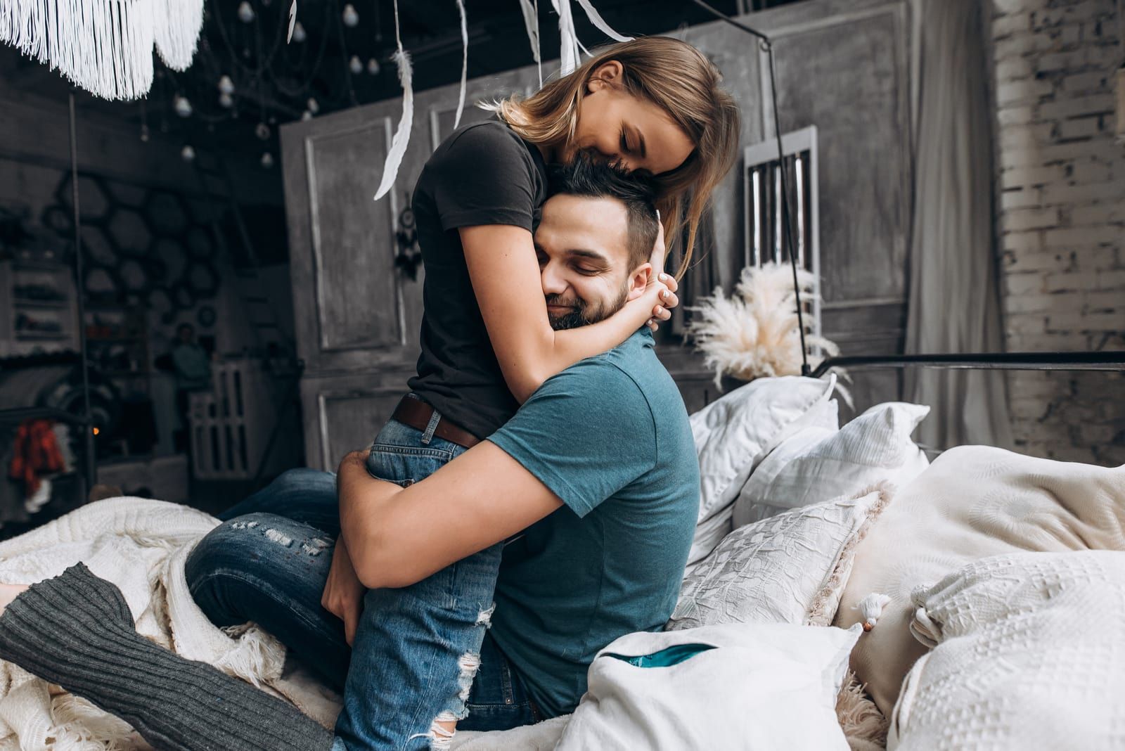 happy couple in love cuddling in bed