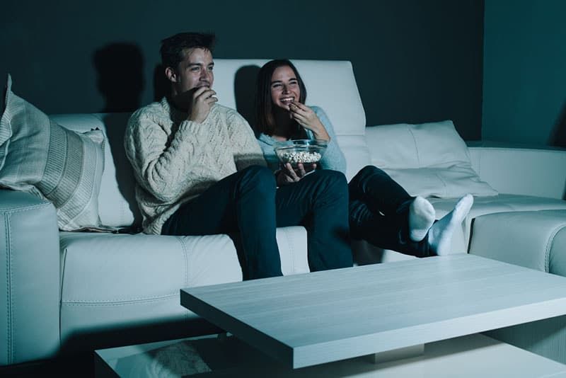 happy couple watching television