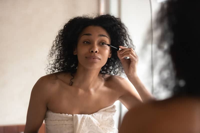 nice woman putting a mascara