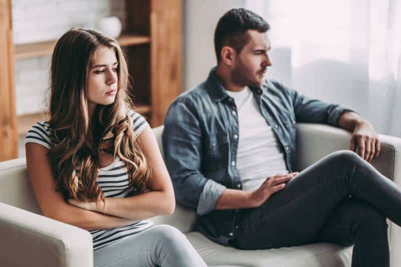 upset couple sitting in living room no talking