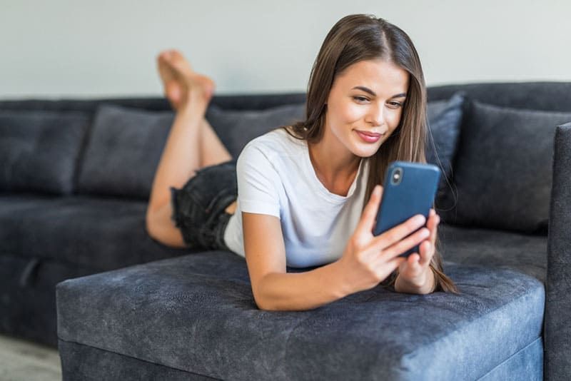 young smiling woman looking at phone