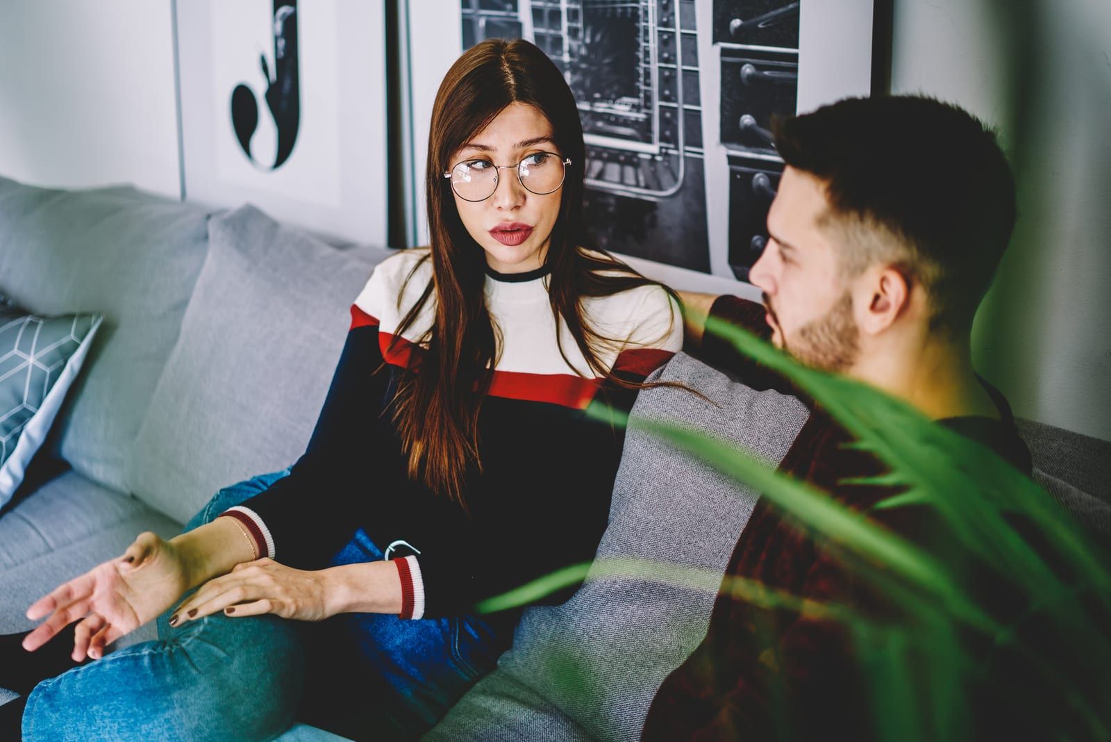couple sitting on couch talking seriously