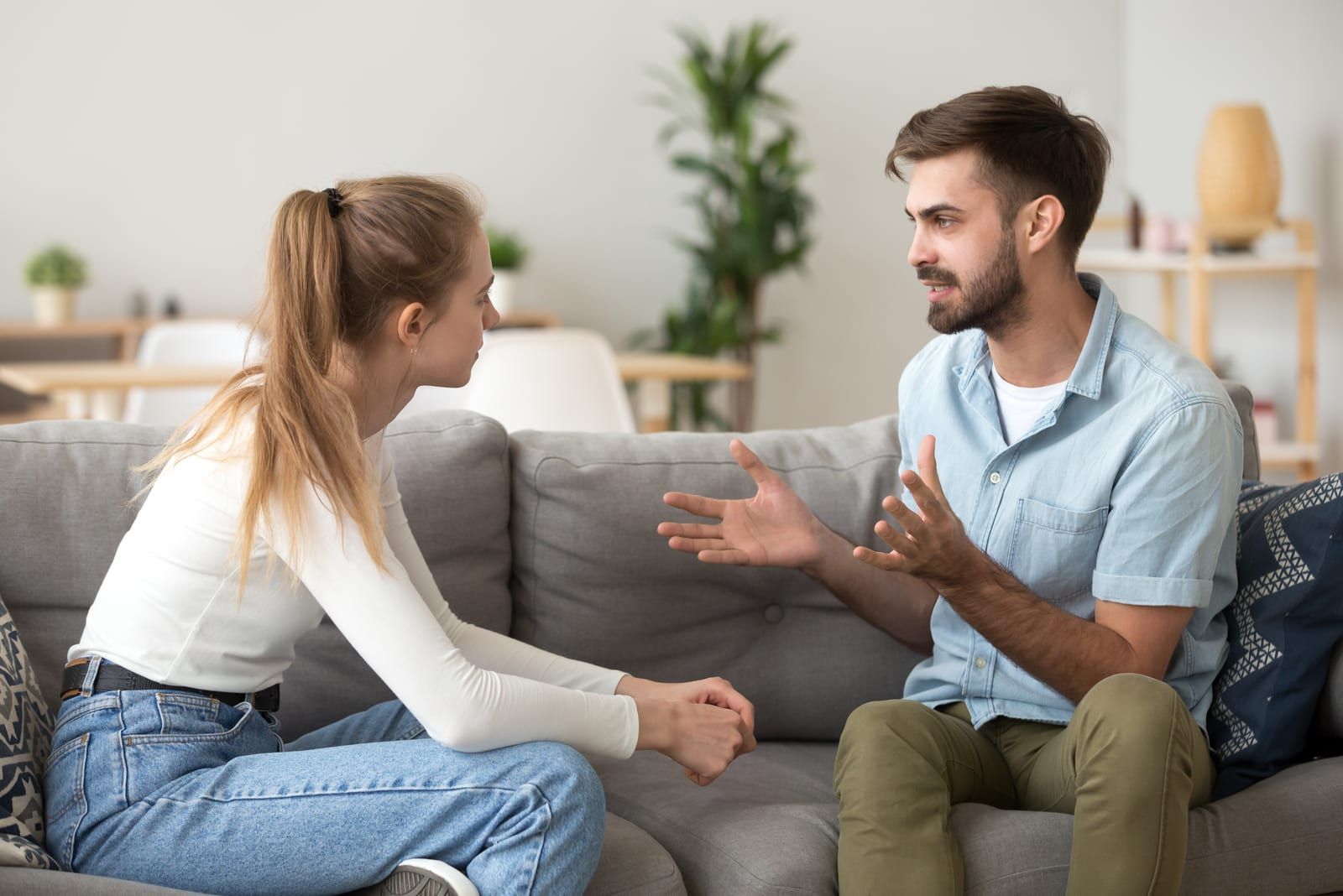 couple sitting on sofa talking