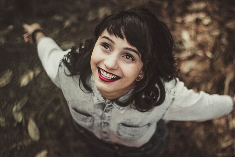 happy woman with dark hair looking up