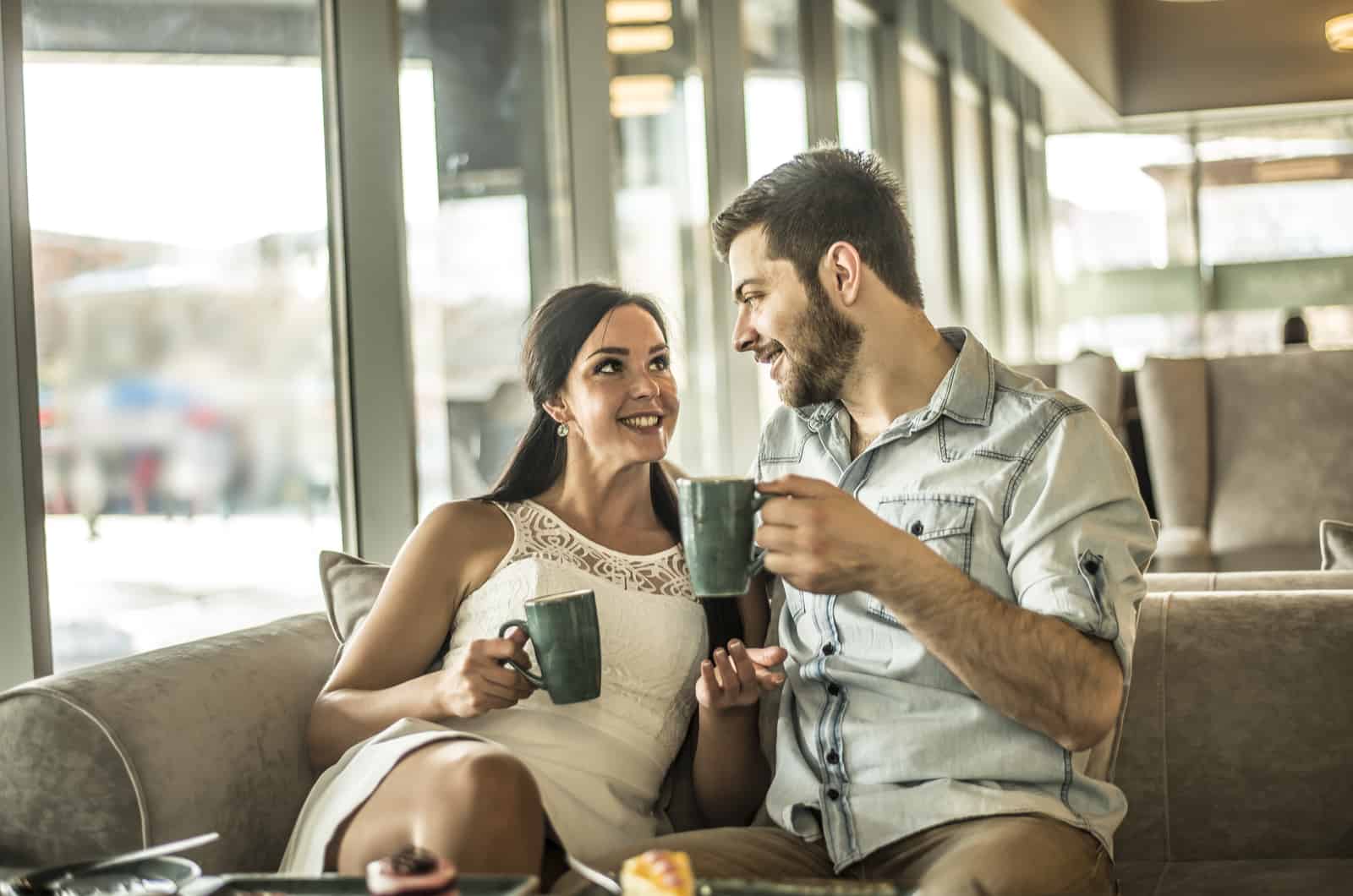 a man and a woman sit next to each other and talk