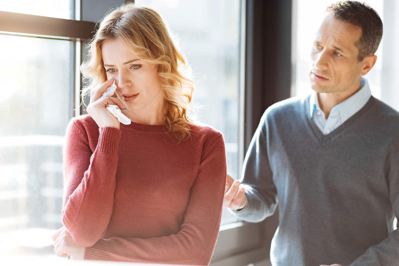 the woman cries while the man talks to her
