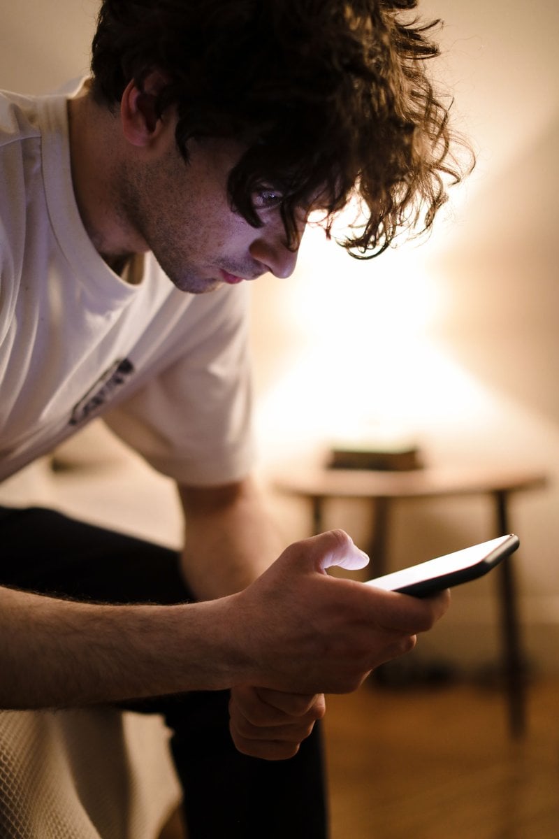 A Man Sitting on the Bed · Free Stock Photo