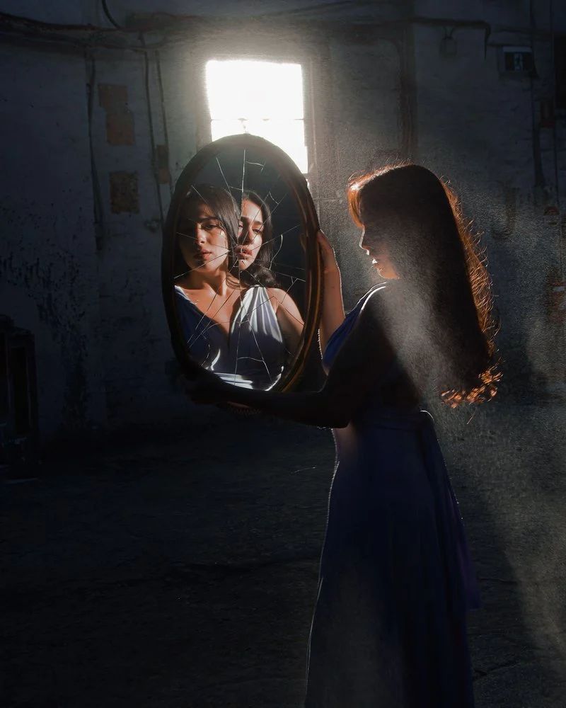Moody Portrait of Woman in Broken Window · Free Stock Photo