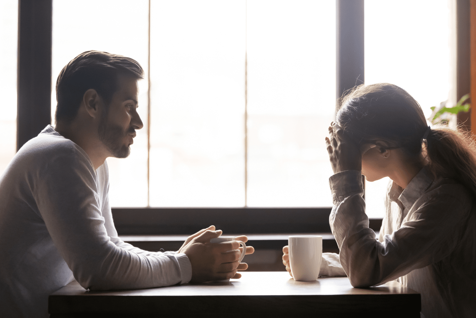 a man is sitting with a woman at the table and they are talking