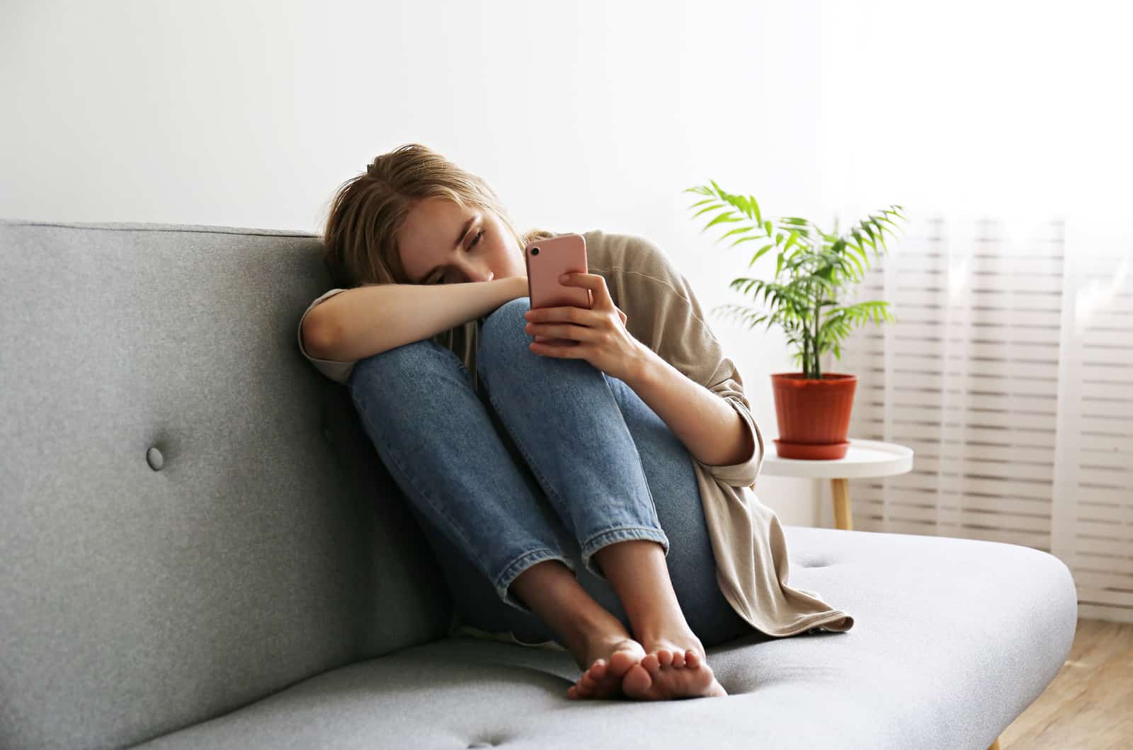 sad woman looking at phone